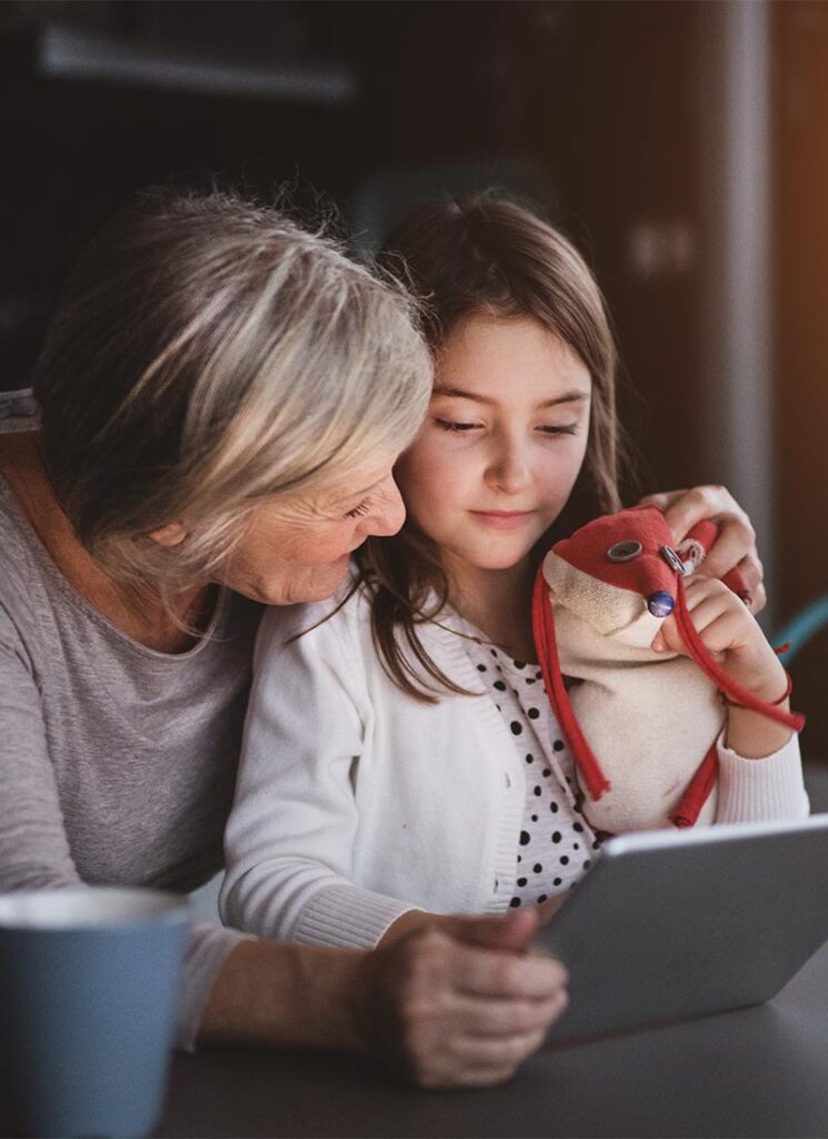 a small girl and grandmother with tablet at home 800